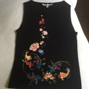 Art. Embroidery, sequins and beads. This pretty sweater has it all.